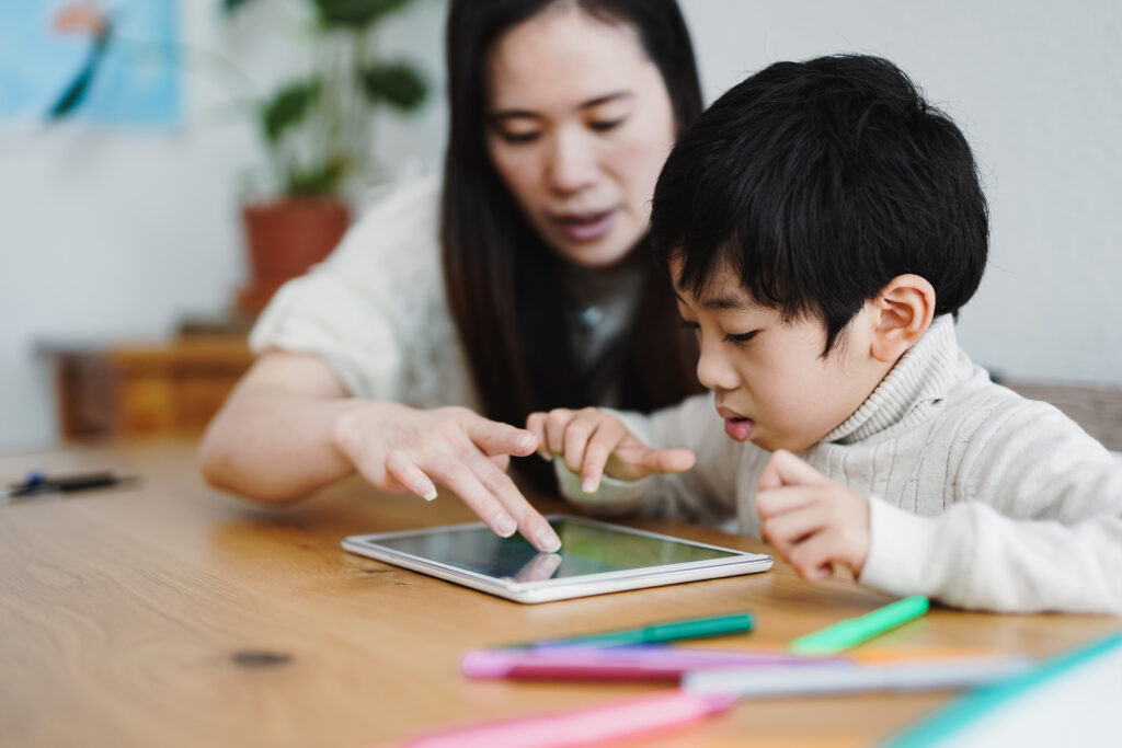 Asian mother and child learning with digital tablet indoor - Day